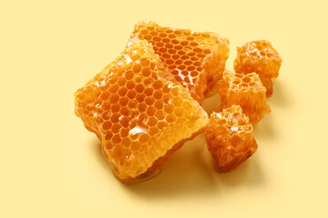 Sweet honeycombs on yellow background