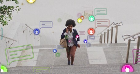 Walking executive carrying tote bag talking on smartphone climbing stone steps showing alerts