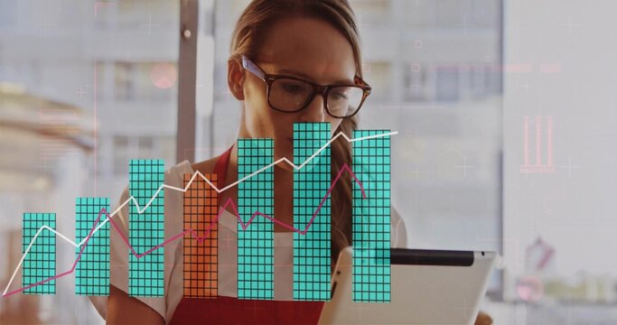 Barista wearing red apron, glasses analyzing data on tablet at cafe window, with chart overlays - Powered by Adobe