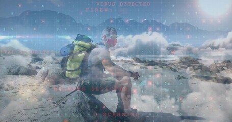 Sitting masked hiker with pole on large rock at shore, with bright green backpack, water bottle