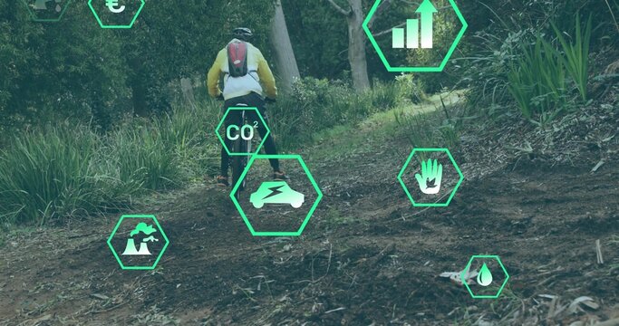 Riding mountain biker wearing yellow jacket helmet backpack on forest trail, with overlay icons