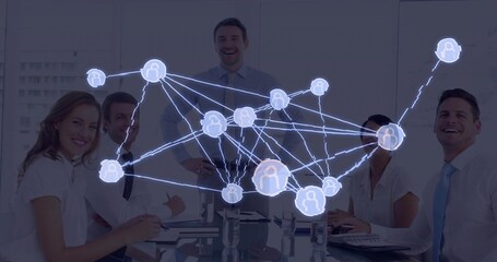 Smiling business professionals collaborating around glass table in conference room, network overlay