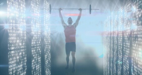 Lifting athlete wearing red top, black shorts pressing barbell overhead in code corridor with mist