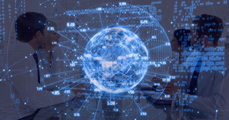 Collaborating colleagues in business attire at meeting table, viewing holographic globe and laptops