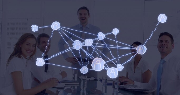 Smiling business professionals collaborating around glass table in conference room, network overlay