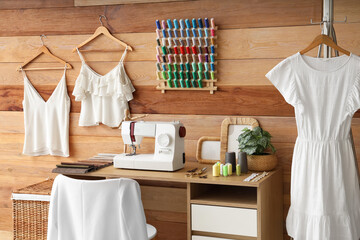 Interior of atelier with tailor's workplace, thread spools and clothes