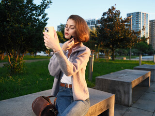 A cheerful Indian business professional is seen texting in a modern office environment. She is smiling and appears engaged, creating a positive and dynamic business atmosphere.