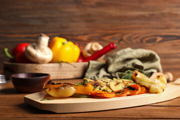 Tray with grilled vegetables on wooden table