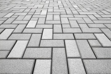 Gray interlocking brick pavement perspective, abstract geometric pattern