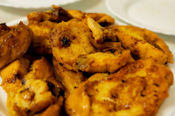 Cooked chicken fillet pieces on white plate