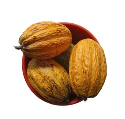 Fresh cacao pods from Guatemala in red bowl isolated on white background