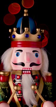 Christmas Toy Nutcracker Soldier on bokeh background of shining Christmas tree lights seasonal winter holidays video