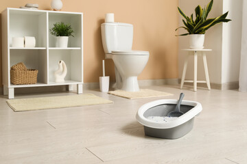 Grey litter box for cat in bathroom