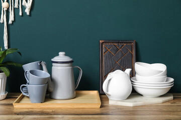 Clean dishes on counter near green wall in kitchen