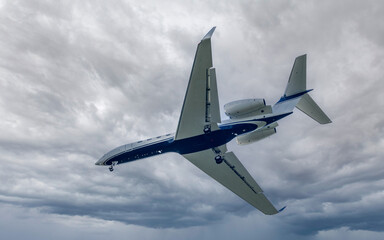Corporate jet on approach to landing. Moody sky.