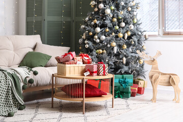 Box with Christmas Advent calendar on table in living room interior