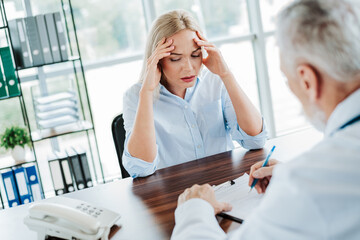 Worried Woman Consults Doctor in a Modern Clinic Office