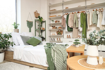 Comfortable bed and big wardrobe in interior of bedroom
