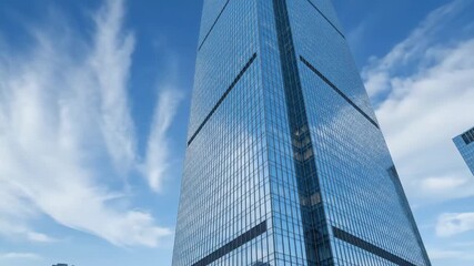 Dynamic Timelapse of a Modern Glass Skyscraper with Fast-Moving Clouds Reflecting on its Gleaming Facade. - Powered by Adobe