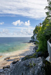 Flowerpot Island lighthouse offers stunning views of craggy cliffs, turquoise waters, and the serene Georgian Bay in Ontario, Canada.