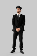 Handsome chauffeur on grey background