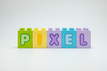 Colorful toy blocks spelling the word PIXEL on a white background. Perfect for technology, education, and creative design projects. Ideal for advertising, presentations, and digital campaigns