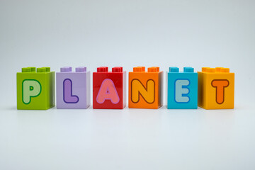 Colorful toy blocks spelling PLANET on a clean white background. Perfect for education, astronomy, science projects, and creative learning resources. Great for posters, books, and school materials
