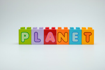 Colorful toy blocks spelling PLANET on a clean white background. Perfect for education, astronomy, science projects, and creative learning resources. Great for posters, books, and school materials