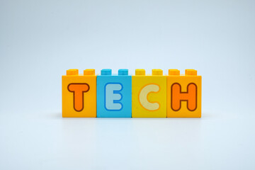 Colorful toy blocks spelling the word TECH on a clean white background. Perfect for illustrating technology, innovation, and digital education projects