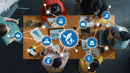 A diverse group of professionals engages in a collaborative business meeting focusing on sustainable practices and growth strategies while analyzing data and ideas. Amity