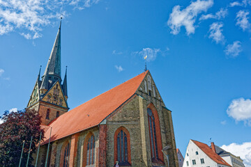 Obraz premium Gothic church tower and chapel windows under blue sky