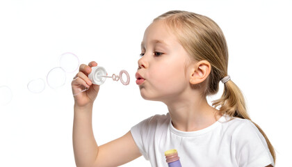 Young girl blowing bubbles on a white background.