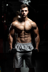 Fototapeta premium Biceps Exercise With Dumbbells In A Gym