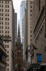 Tall historic skyscrapers rising above Wall Street in Manhattan