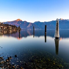 Lakeside sunrise, calm water reflections