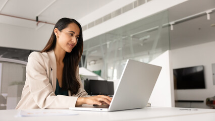 Beautiful young executive woman working on company online project