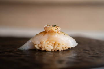 O-toro Sushi with Grilled Hotate Scallop and Yuzu Kosho, Japanese Cuisine, Omakase-style Dinner, Premium Fresh Raw Fish and Rice on Black Stone Plate.