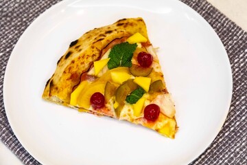 The iconic, wonderful, and unique California pizza, made with Canadian pork tenderloin and tropical fruits—pineapple, mango, fig, peach, and cherries—garnished with fresh mint leaves. 