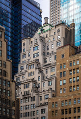 Fototapeta premium Fifth Avenue in Manhattan with skyscrapers, trees, and yellow taxi