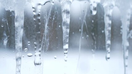 Close up of melting icicles on a window with water droplets. - Powered by Adobe