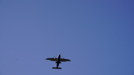 Looking Up at a Single-Engine Aircraft against a Vast Blue Sky
