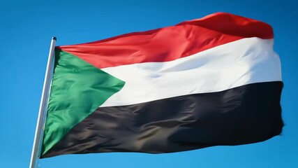 Sudanese Flag Waving in the Wind Against a Clear Blue Sky