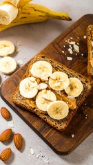 Healthy breakfast sandwich with banana, peanut butter, and almonds