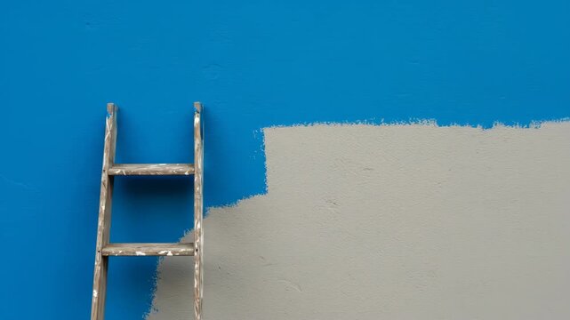 Painted wall with a ladder, half finished renovation process