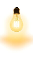 A glowing vintage-style light bulb hangs against a plain white background, emitting a warm yellow light.