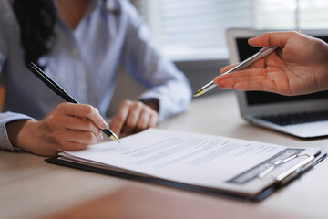 Businesswoman signing contract after lawyer explanation