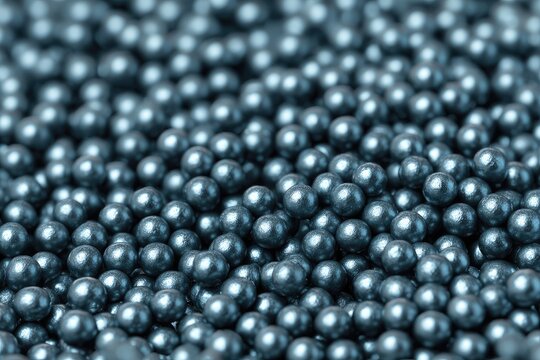 Close-up of many small, dark-gray, round beads