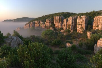 Misty mountain landscape with rocky outcrops and vegetation