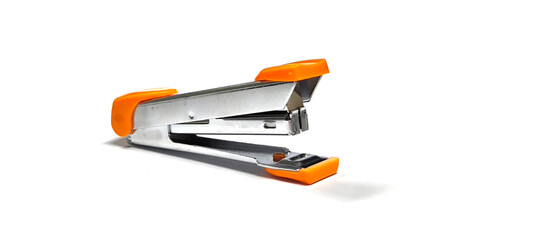 Orange stapler on white background. Office supplies.