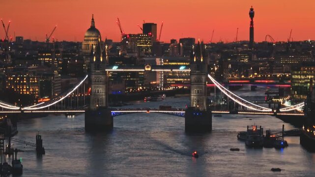 England, London: Aerial view of Tower Bridge, St. Paul's Cathedral, and BT Tower, creating stunning cityscape against the backdrop of a vibrant sunset in London, United Kingdom capital night skyline